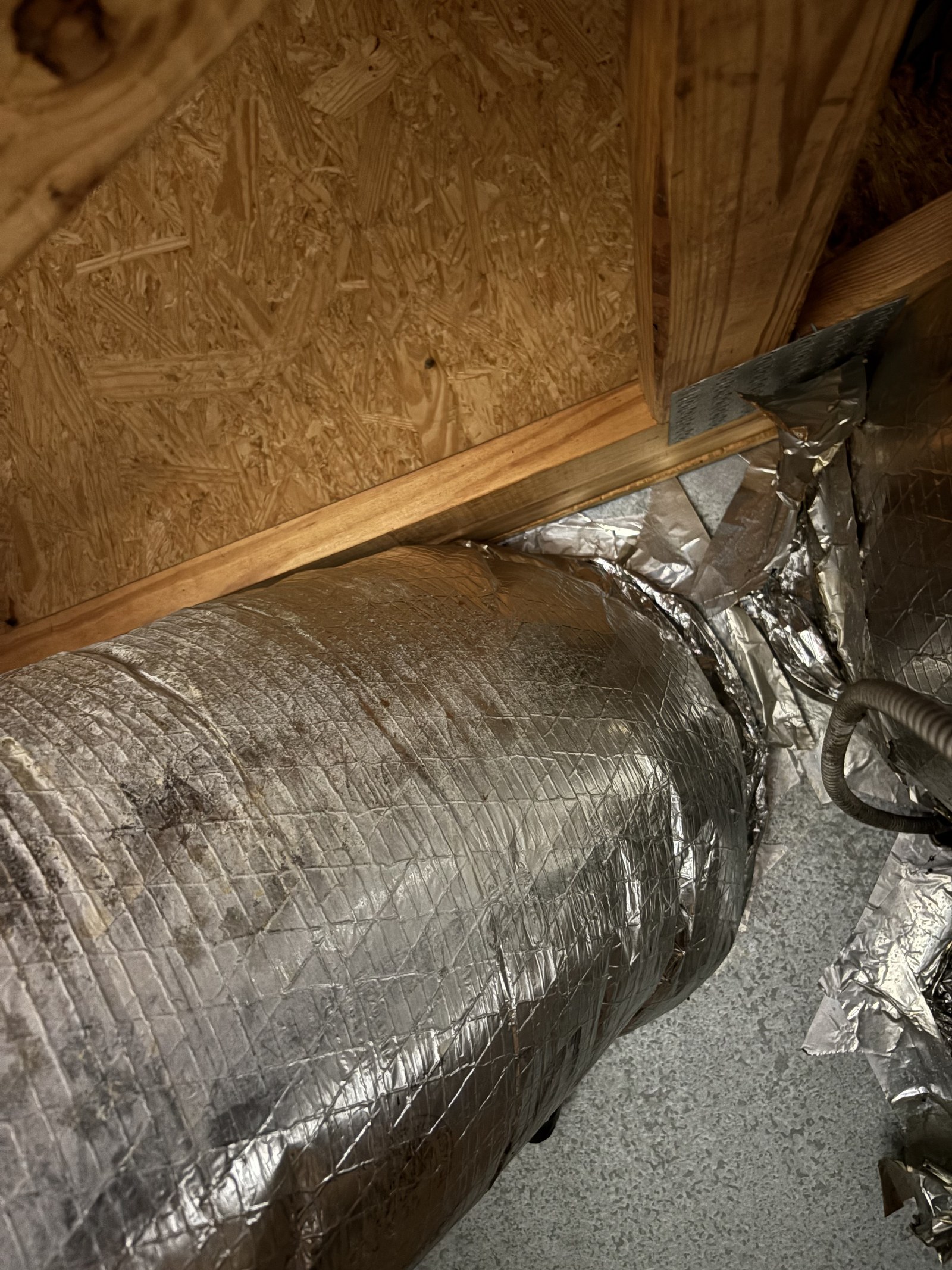 Insulated flex duct reattached and secured to the plenum connection