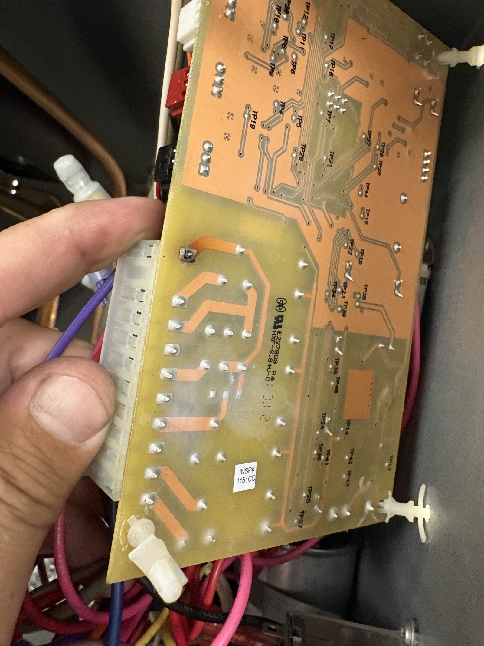 Back of a failed ice machine control board removed after the repair